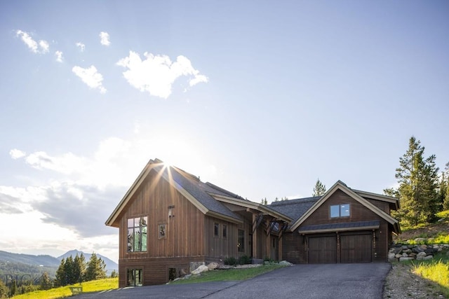 13 Middle Rider, Big Sky, MT 59716 - view of front of home featuring a garage, asphalt driveway, and a mountain view