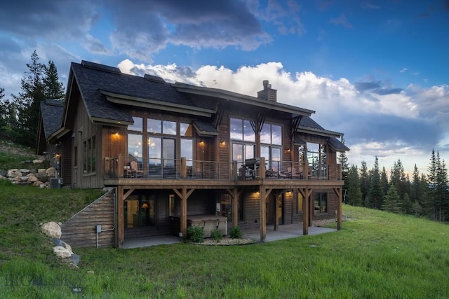13 Middle Rider, Big Sky, MT 59716 - rear view of property with a patio area, a chimney, a lawn, a deck, and stairs