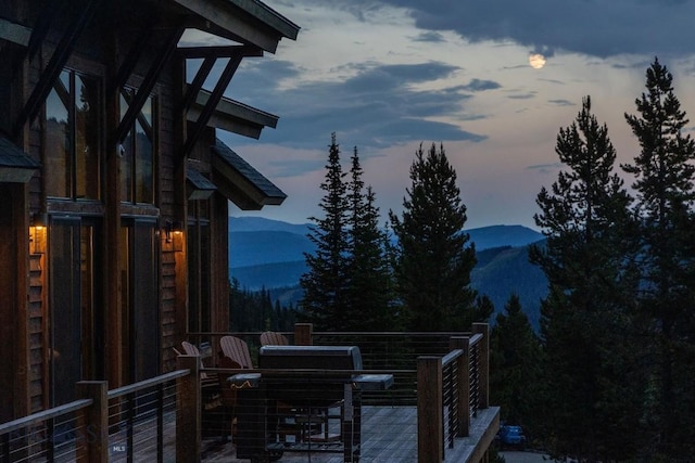 13 Middle Rider, Big Sky, MT 59716 - deck at dusk featuring a mountain view and area for grilling