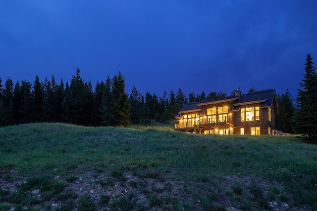 13 Middle Rider, Big Sky, MT 59716 - back of house at night with a forest view