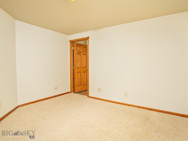 spare room featuring light colored carpet