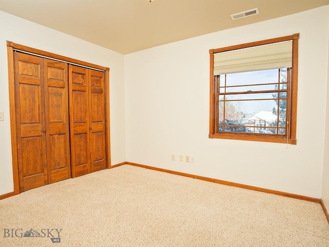 unfurnished bedroom with a closet and carpet floors