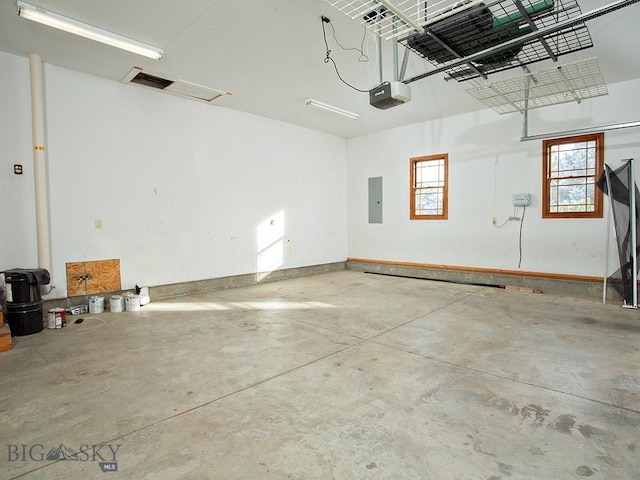 garage featuring electric panel and a garage door opener