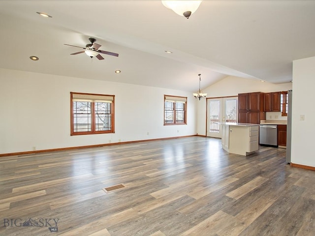 unfurnished living room featuring french doors, ceiling fan with notable chandelier, wood-type flooring, and lofted ceiling