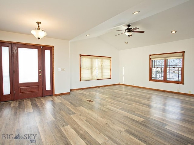 entrance foyer featuring ceiling fan, lofted ceiling, and hardwood / wood-style flooring