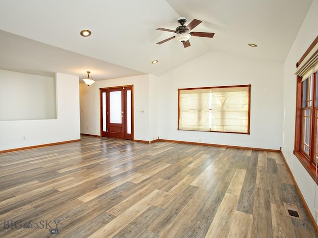 unfurnished living room with ceiling fan, dark hardwood / wood-style flooring, and vaulted ceiling