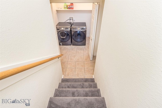 stairs with washing machine and clothes dryer and tile patterned floors