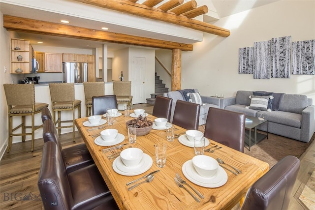 dining space featuring beam ceiling and dark wood-type flooring