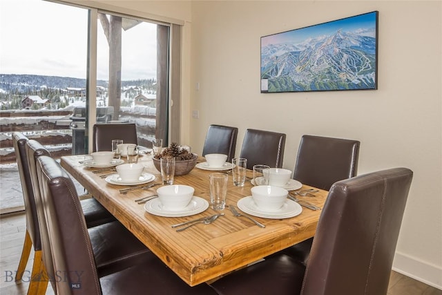 dining room with a mountain view and hardwood / wood-style flooring