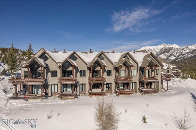 snow covered property featuring a mountain view