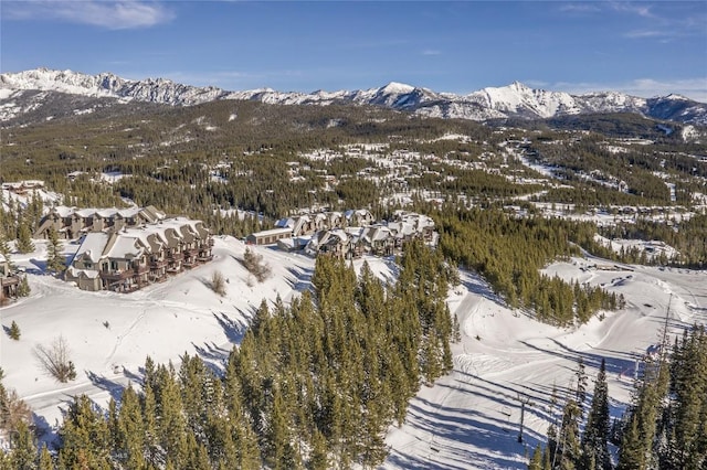 snowy aerial view with a mountain view