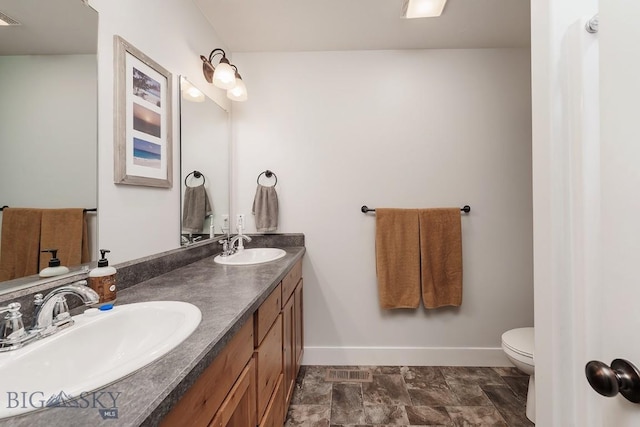 bathroom with vanity and toilet