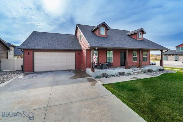 cape cod house with a garage, covered porch, and a front yard