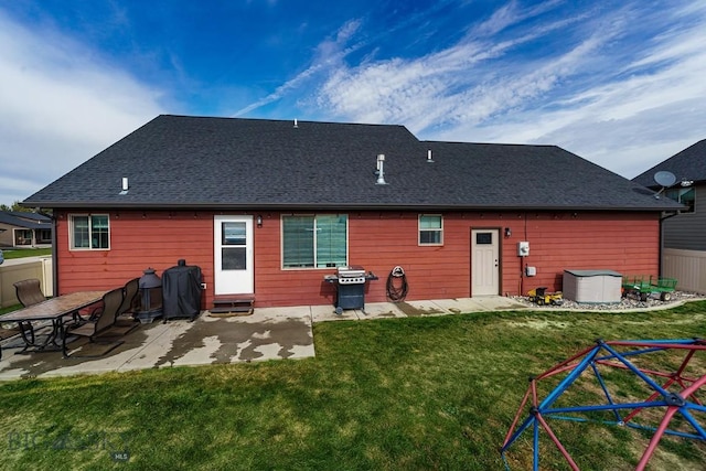 back of property with a patio and a yard