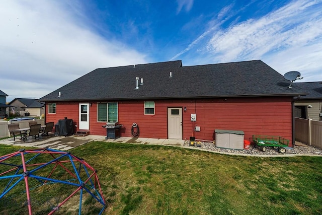 rear view of house with a yard and a patio area