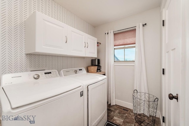 laundry room featuring cabinets and washer and dryer