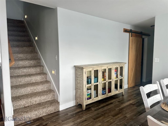 staircase featuring hardwood / wood-style flooring and a barn door