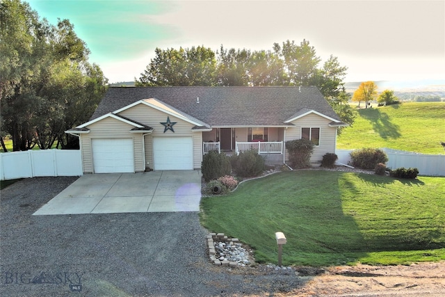 ranch-style home with an attached garage, covered porch, fence, concrete driveway, and a front lawn