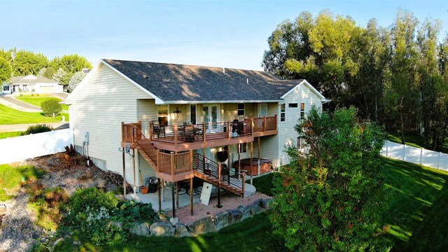 back of house with a wooden deck, a yard, a patio, and a hot tub