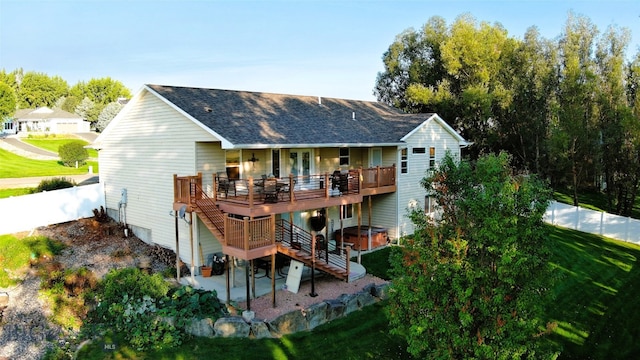 1191 Chipper Ln, Huntley, MT 59037 - back of property featuring a lawn, a patio area, fence, a deck, and a jacuzzi