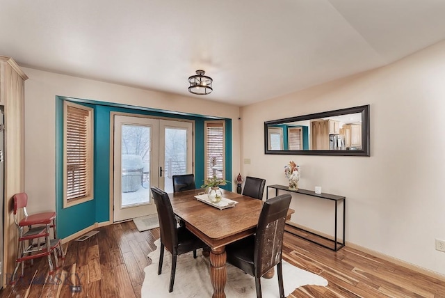 1191 Chipper Ln, Huntley, MT 59037 - dining space with french doors, visible vents, baseboards, and wood finished floors