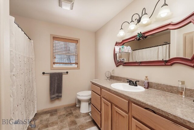 1191 Chipper Ln, Huntley, MT 59037 - bathroom featuring visible vents, toilet, vanity, and baseboards