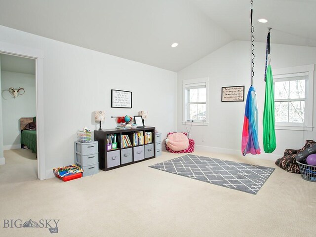 recreation room with lofted ceiling, carpet, and a wealth of natural light