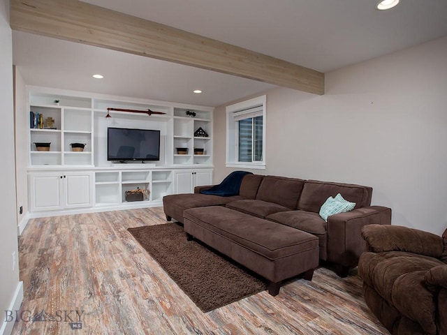 living room featuring beam ceiling and light hardwood / wood-style floors