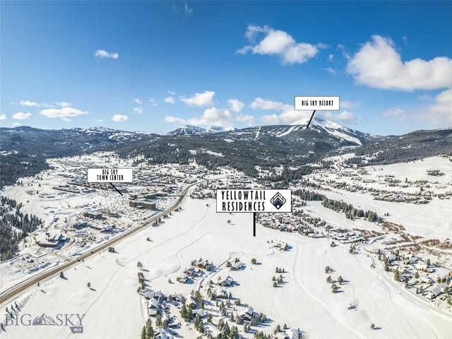 snowy aerial view featuring a mountain view