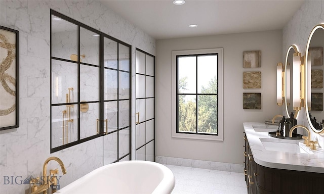 bathroom featuring a bathtub, a healthy amount of sunlight, and vanity