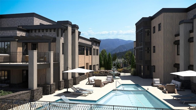 view of pool featuring a pergola, a patio area, a mountain view, and an outdoor hangout area