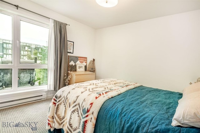 bedroom with carpet floors and baseboard heating