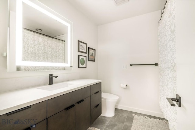 bathroom featuring vanity and toilet