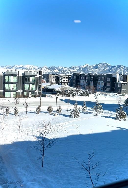 snowy yard featuring a mountain view