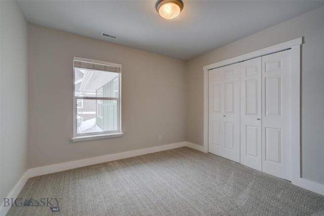 unfurnished bedroom with a closet and carpet