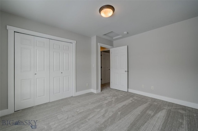 unfurnished bedroom with a closet and light colored carpet