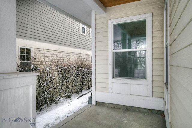 view of snow covered property entrance