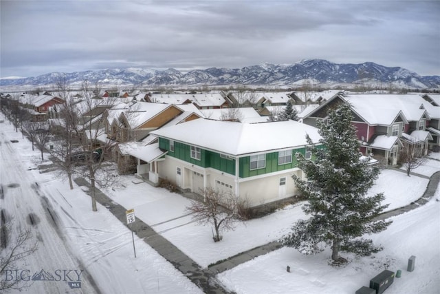 snowy aerial view with a mountain view