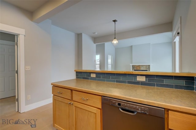 kitchen featuring hanging light fixtures, stainless steel dishwasher, decorative backsplash, beam ceiling, and light hardwood / wood-style floors