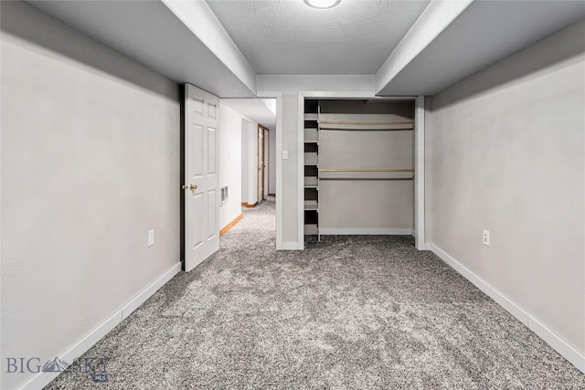 unfurnished bedroom with carpet flooring, a closet, and a textured ceiling