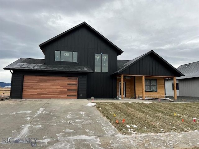 view of front of property with a porch and a garage