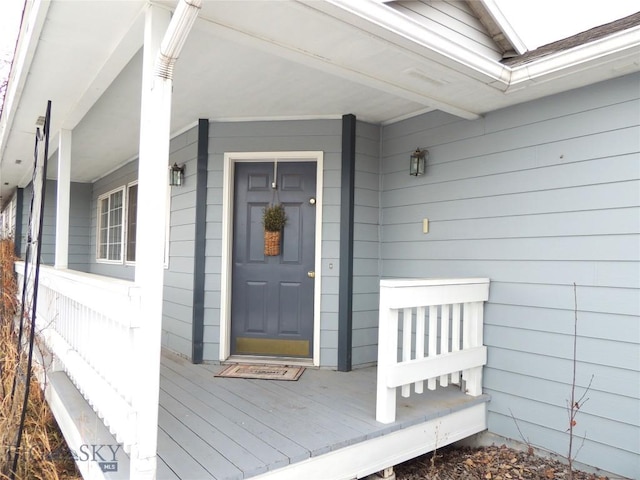 view of exterior entry with a porch