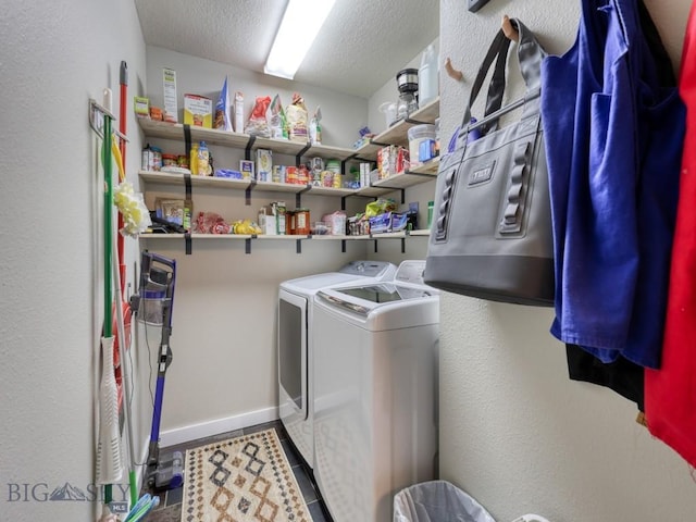 laundry room featuring tile patterned flooring, washer and dryer, and a textured ceiling