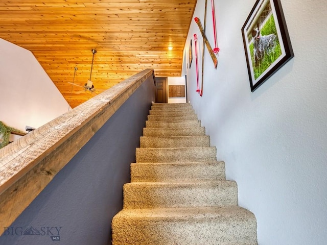 stairway featuring ceiling fan, wooden ceiling, and lofted ceiling