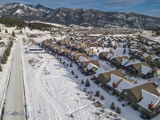 snowy aerial view featuring a mountain view