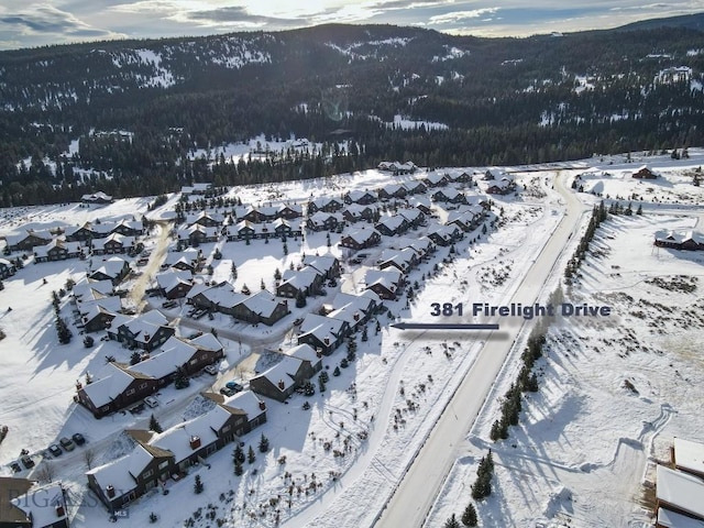 snowy aerial view with a mountain view