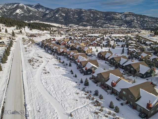 snowy aerial view with a mountain view