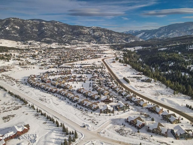 snowy aerial view featuring a mountain view