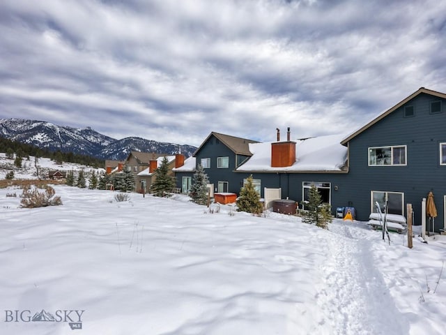 snow covered property featuring a mountain view