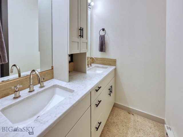 bathroom with vanity and a baseboard heating unit